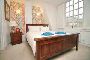 a bedroom with a large bed with blue towels on it at The Cardiff Central Pad – Stylish 2-Bed Apartment in Cardiff