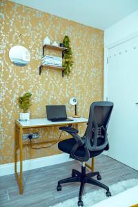 an office with a desk with a chair and a laptop at The Cardiff Central Pad – Stylish 2-Bed Apartment in Cardiff +2 photos