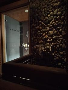 a stone wall in a bathroom with a television at Cozy detached house near the city in Rovaniemi +34 photos