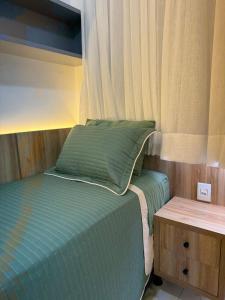 En eller flere senge i et værelse på Apartamento novo e completo