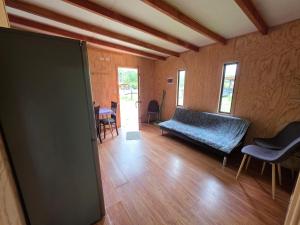 a living room with a couch and a table at Cabaña Playa Chauquen in Neltume