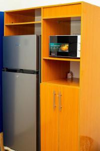 a kitchen with a refrigerator and a microwave at Soothing Haven in Ibadan