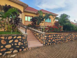 a house with a staircase leading up to it at Good Times in Kampala