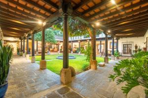 an outdoor patio with a wooden pergola at Las Cruces Boutique Hotel in Antigua Guatemala