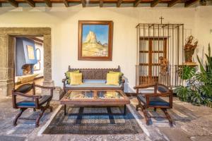 a living room with a couch and two chairs at Las Cruces Boutique Hotel in Antigua Guatemala