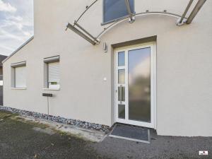 a door on the side of a house at Winter Garden Dream Steinheim in Steinheim an der Murr +2 photos