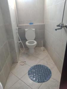 une petite salle de bain avec toilettes et douche dans l'établissement Ensuite rooms in a furnished apartment in Tudor, Mombasa TF1, à Mombasa