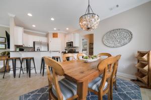 una cucina e una sala da pranzo con tavolo e sedie in legno di Sandy Bottoms a Santa Rosa Beach