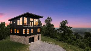 a black house on top of a hill at Scenic Getaway Cabin w/ Fire Pit, Deck & Panoramic Views in Martinsburg, WV in Martinsburg
