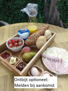 a wooden tray filled with different types of food on a table at The Walnut Tree in Hellevoetsluis +14 photos
