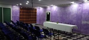 a room with a white table and blue chairs at Auberge Lion de l'Atlas in Azrou
