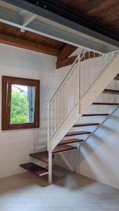 a white staircase in a room with a window at Foresteria - Riolo in Schio