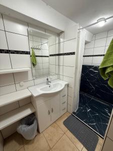 a white bathroom with a sink and a shower at Apartment bei Oberndorf - Schwanenstadt in Schwanenstadt
