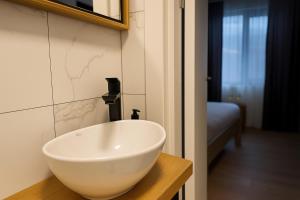a bathroom with a white bowl sink on a counter at Transrarau Lodge in Pojorîta +13 photos