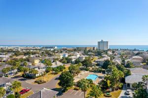 an aerial view of a resort with a pool and buildings at Sunny and Share in Destin