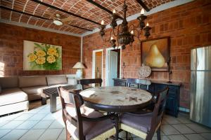 a living room with a table and a couch at Mama Chuy Hotel & Villas Ajijic in San Juan Cosalá