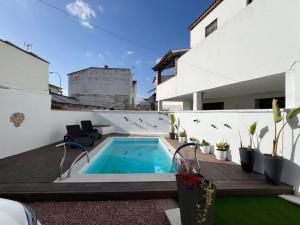 a backyard with a swimming pool and a house at Los Ángeles de Sanmartín in Jimena de la Frontera