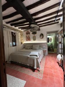 a bedroom with a large bed and a ceiling at Los Ángeles de Sanmartín in Jimena de la Frontera