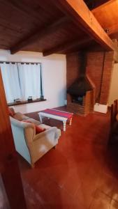 a living room with a couch and a fireplace at Corazonada in Volcán