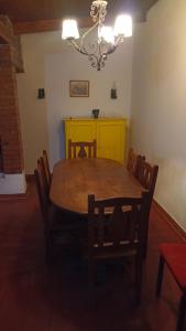 a dining room with a wooden table and chairs at Corazonada in Volcán
