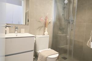 a bathroom with a shower and a toilet and a sink at Central House in Limassol