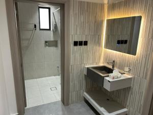 a bathroom with a sink and a shower at قمرة قباء Cuba moon2 in Al Madinah +1 photo