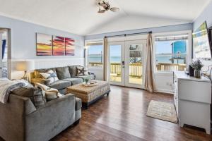 a living room with a couch and a table at 8077 - Beachin' It in South Rodanthe