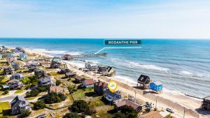 an aerial view of a beach with a sign at 8077 - Beachin' It in South Rodanthe
