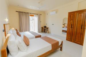 Postel nebo postele na pokoji v ubytování Arco Mirissa