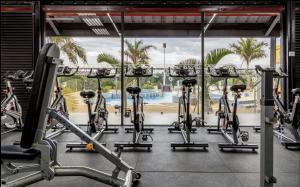 a row of exercise bikes in a gym at Cozy 2 BR Tatu City - Unity Homes in Oloyaingalani +29 photos