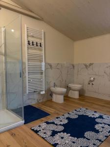 a bathroom with a shower and a toilet and a sink at Sangida Home in Lamezia Terme +5 photos