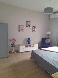 a bedroom with a bed and a table and a chair at Casa Carla in Granadilla de Abona