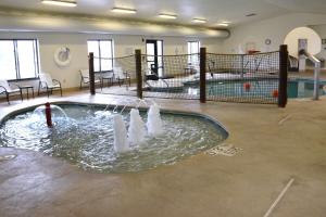 a swimming pool with water fountains in a building at Holiday Inn Express & Suites Sidney by IHG in Sidney +12 photos