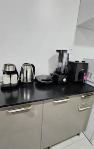 a kitchen counter with pots and pans on it at Vitallino Apartment | Modern with A/C, 10 min from the City Center in Caruaru