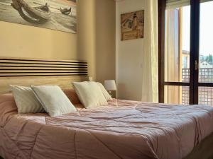 a bedroom with a large bed with a large window at Casa BELLOCCHIO in Perugia