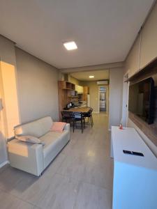 a living room with a couch and a table at Apartamento 101 Farol de Santa marta in Laguna +3 photos