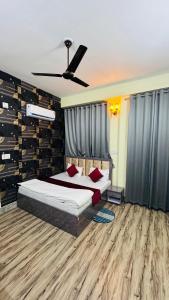 a bedroom with two beds and a ceiling fan at SUNRISE INN hotel in Bikaner