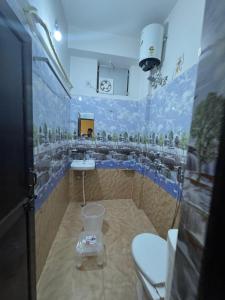 a bathroom with a sink and a toilet in it at SUNRISE INN hotel in Bikaner
