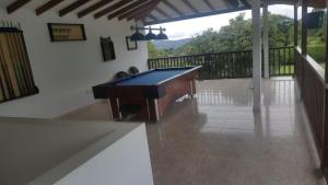 a pool table in a room with a balcony at Villa Del Viento in Calima