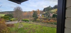 a view from a window of a house with a garden at Chalet du Feignole in Gerbépal