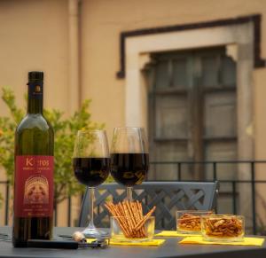 a table topped with plates of food and bottles of wine at Residence Degli Agrumi in Taormina