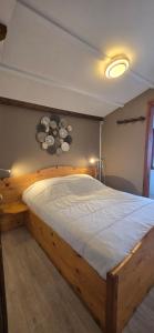 a bedroom with a wooden bed in a room at Chalet du Feignole in Gerbépal