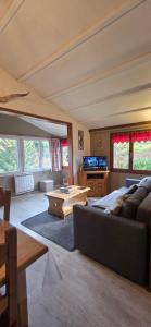 a large living room with a couch and a table at Chalet du Feignole in Gerbépal