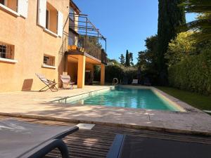 a swimming pool in a yard next to a building at la grande villa in Aix-en-Provence +25 photos