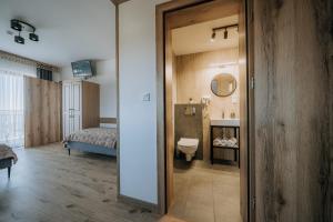 a bathroom with a bed and a toilet in a room at Willa Janowa & SPA in Bukowina Tatrzańska +191 photos