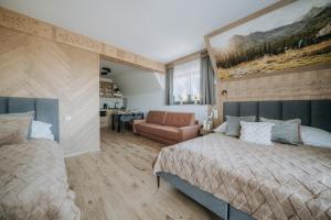 a bedroom with a bed and a couch in it at Willa Janowa in Bukowina Tatrzańska