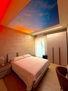 a bedroom with a bed with a painting on the ceiling at Ludogà Luxury Suite in Trebisacce