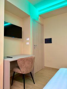 a room with a desk and a chair and a bed at Ludogà Luxury Suite in Trebisacce