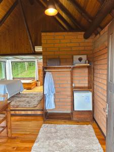 a room with a bedroom and a bed in a house at Maria Rita dos Canyons in Praia Grande