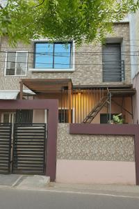 a building with a fence and a staircase on it at Alfiya Residency - Green Park in Indore